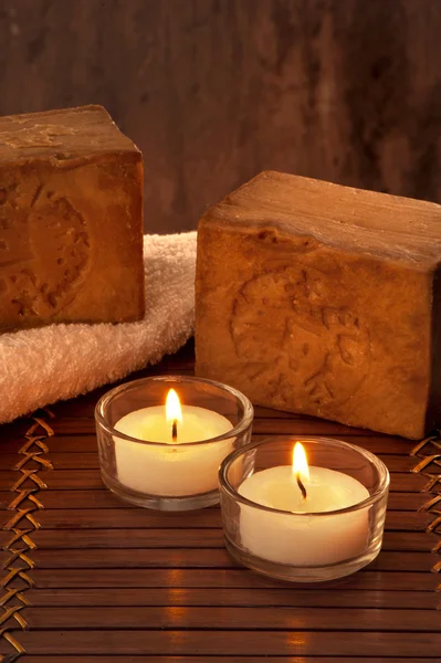 SPA atmosphere with two candles with light and soap — Stock Photo, Image