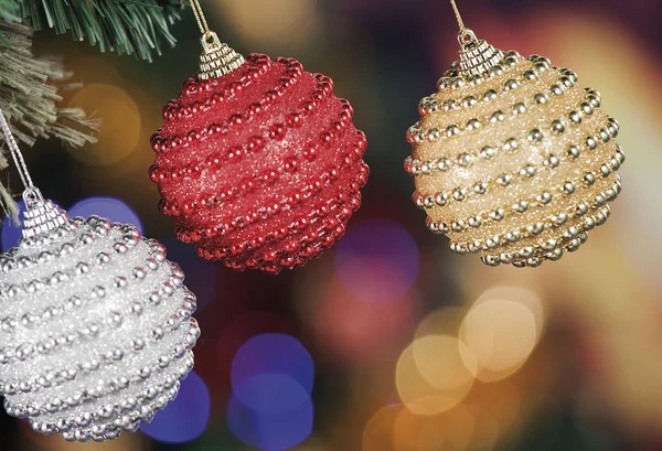 Christmas baubles on background of defocused lights — Stock Photo, Image