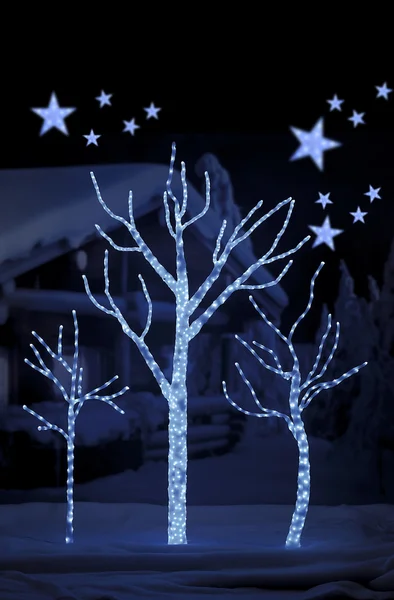 Stars on background of defocused blue lights and tree — Stock Photo, Image