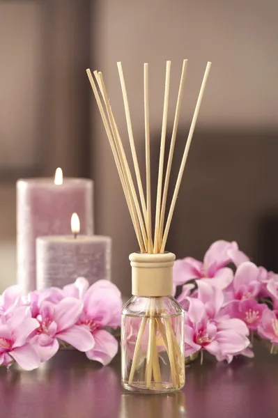 Air freshener sticks at home with flowers and ou of focus backgr — Stock Photo, Image