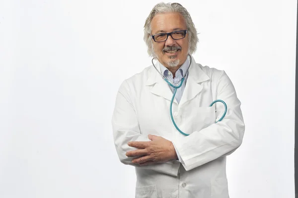 Caucasian mature male doctor on bright background — Stock Photo, Image