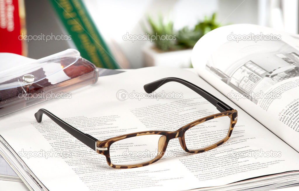 reading glasses endorsed on a magazine at home