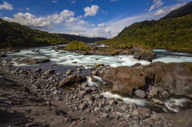 Beautiful Patagonian waterfall in a forest lit by the rising sun of Patagonia