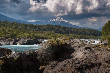 Beautiful Patagonian waterfall in a forest lit by the rising sun of Patagonia