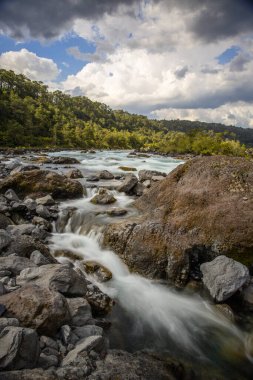 Beautiful Patagonian waterfall in a forest lit by the rising sun of Patagonia