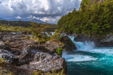 Beautiful Patagonian waterfall in a forest lit by the rising sun of Patagonia