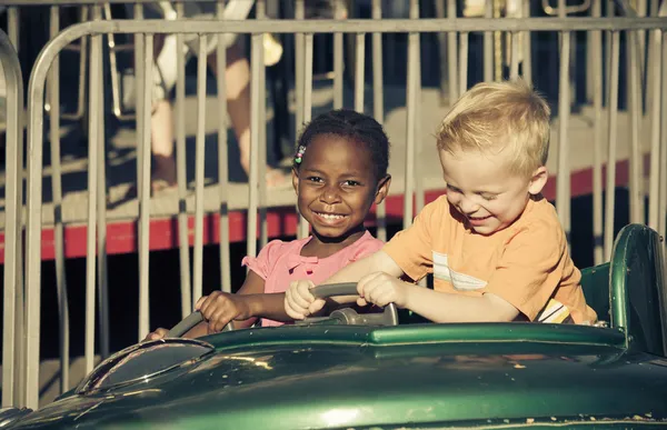 Kids on an amusement park ride — Stock Photo, Image