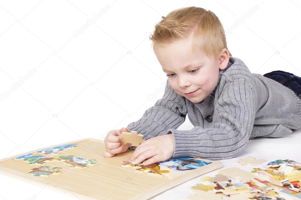 Young boy solving a puzzle