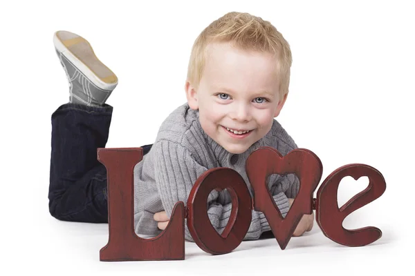 Adorable little boy sending out a message of love — Stock Photo, Image