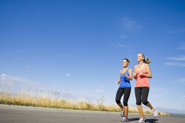Two beautiful women on morning run outdoors