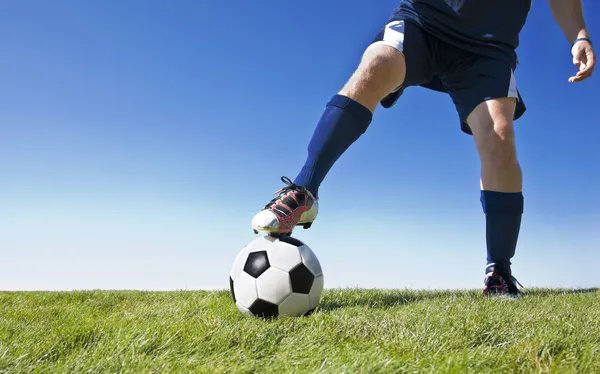 Soccer player kicking the ball during a game — Stock Photo, Image