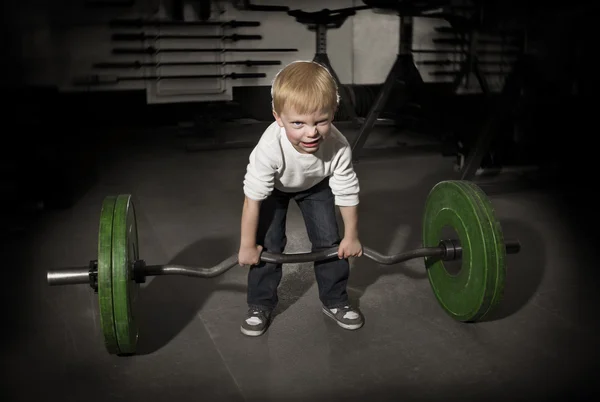 Determined Young Boy trying to lift Heavy weights — Stock Photo, Image