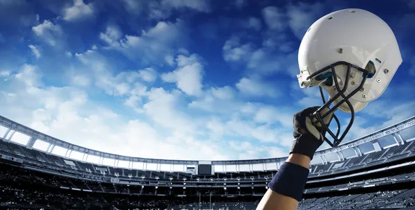 Football player raises his helmet — Stock Photo, Image