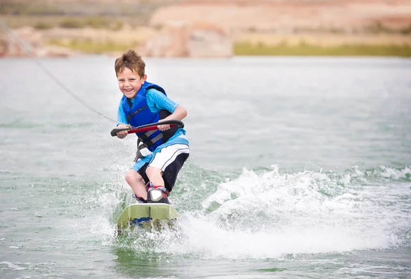 Sorridente bambino imparare a wake-board — Foto Stock