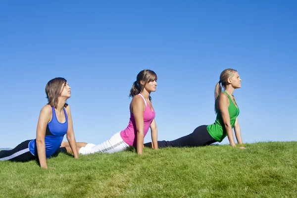 Mujeres estirándose y haciendo yoga —  Fotos de Stock