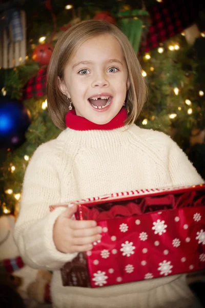 Little girl opening gifts on Christmas morning — Stock Photo, Image