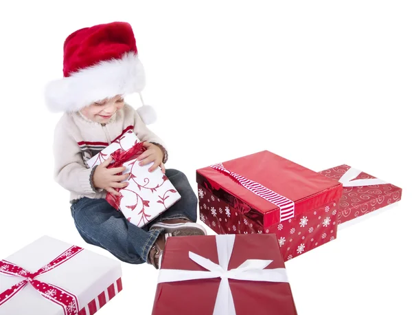 Niño abre regalos de Navidad —  Fotos de Stock