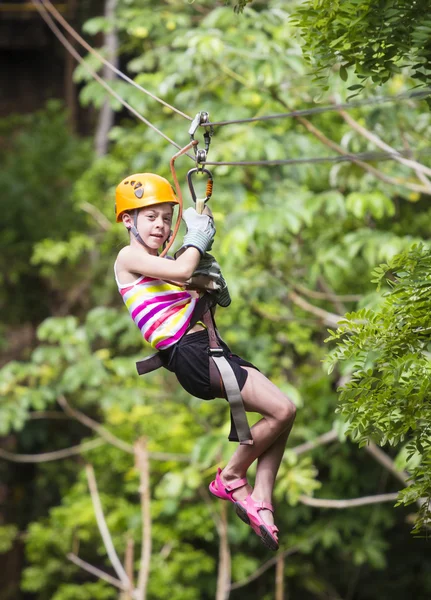 Young girl on a jungle zipline — Stock Photo, Image