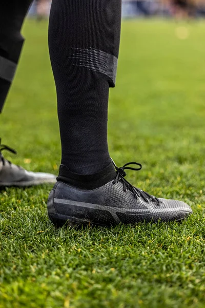 Close up view of a soccer (football) player\'s legs and cleats. Vertical Generic soccer or football photo