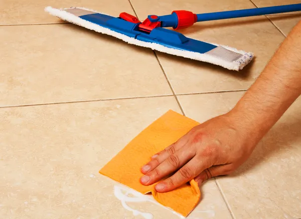 Hand with sponge clean a house floor — Stock Photo, Image