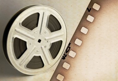 Old motion picture film reel with film strip clipart