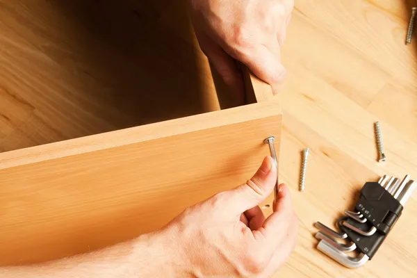 Carpenter mounting wooden furniture — Stock Image Carpenter mounting wooden furniture Royalty Free Stock Images