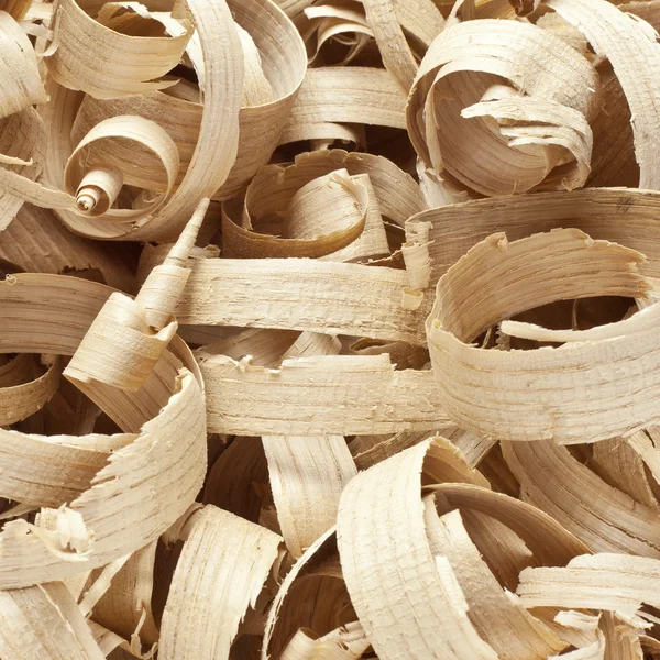 Wooden shavings in workshop on planks — Stock Photo, Image