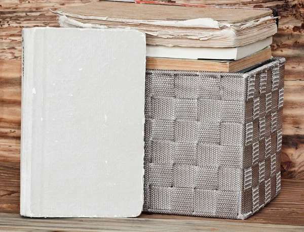 Books in fabric box on woodenshelf — Stock Photo, Image