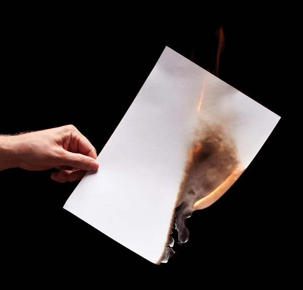 Homem mão segurando papel branco queimado — Fotografia de Stock