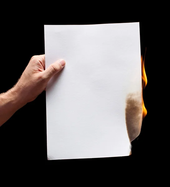 Homem mão segurando papel branco queimado — Fotografia de Stock