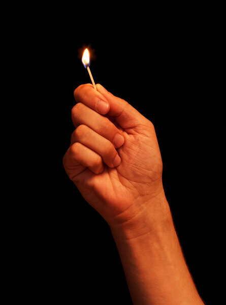 Man hand holding burning match