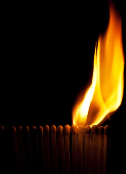 Burning matchsticks on black background — Stock Photo, Image