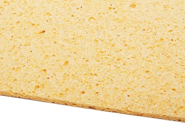 Yellow kitchen sponge is isolated on a white — Stock Photo, Image