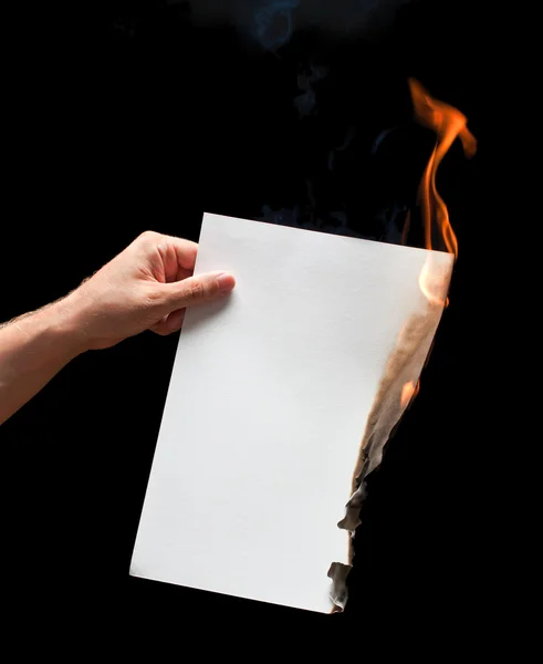 Man hand holding white burned paper — Stock Photo, Image