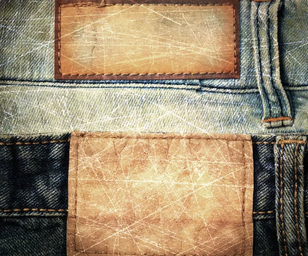 Grunge çizilmiş deri jeans etiket üzerinde kot pantolon diktim. — Stok fotoğraf