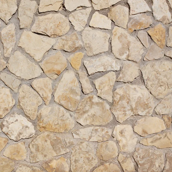 光の古い石造りの壁の背景 — ストック写真