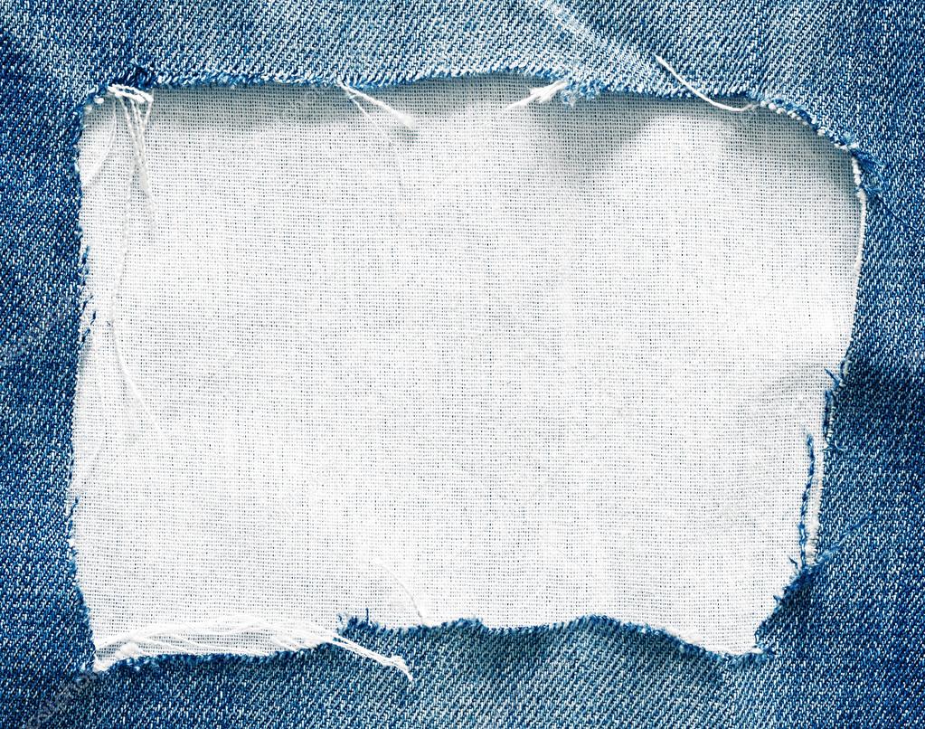 Blue torn jeans on white fabric texture