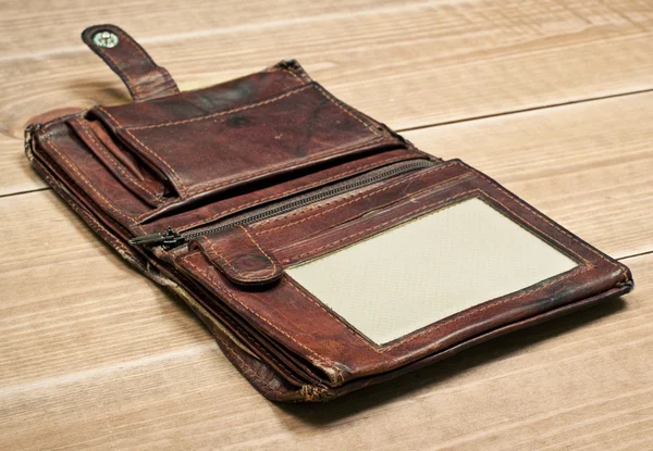 Opened old purse on wooden table — Stock Photo, Image