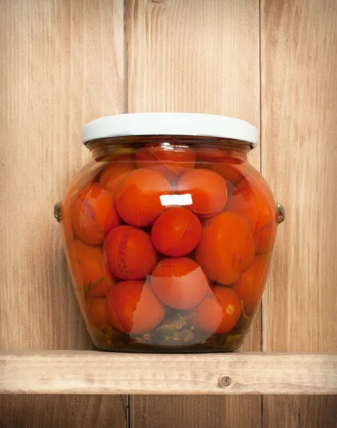 Preserved  vegetable on shelf near a brown wooden wall — Stock Photo, Image