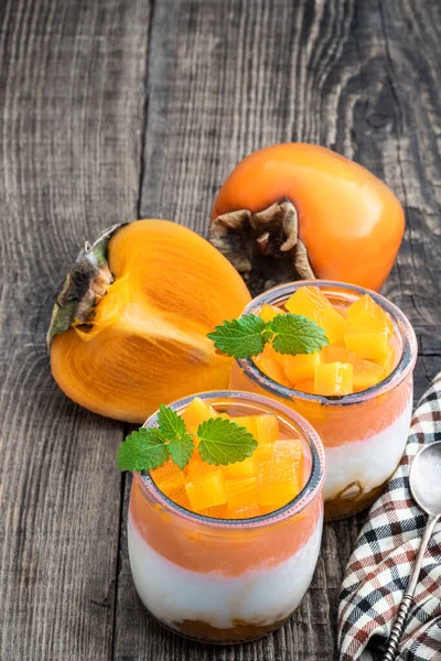 White Fruity Yogurt Persimmon Slices Glass Jars Wooden Table — стоковое фото