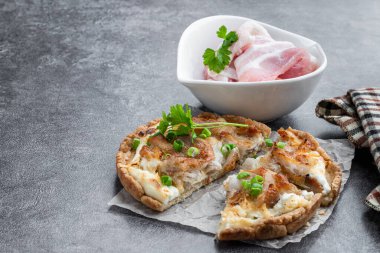 Mini  pie with onion and bacon on gray background 