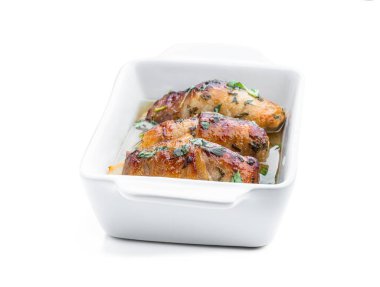 Chicken  breasts wrapped in bacon in white dish isolated on white 