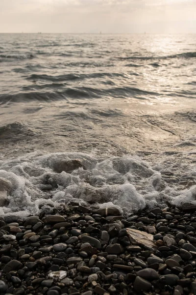 Deniz dalgaları kıyıdaki çakıl taşlarına çarpıyor. Telifsiz Stok Imajlar