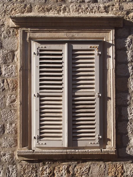 Ventana de piedra mediterránea con persianas de madera —  Fotos de Stock