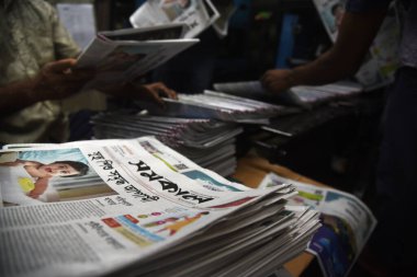 Employees check the printing quality of the edition of the Daily Samakal newspaper at the printing press in Dhaka, Bangladesh, on August 10, 2022. The Daily Samakal is a Bangla newspaper one of the most popular newspaper in Bangladesh