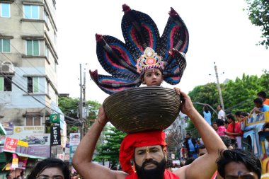 Hindu devotees take part in a procession during celebrations for the 'Janmashtami' festival, which marks the birth of Hindu god lord Krishna, in Dhaka, Bangladesh, on August 19, 2022.
