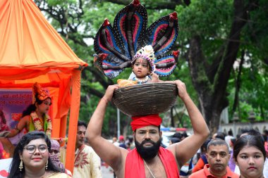 Hindu devotees take part in a procession during celebrations for the 'Janmashtami' festival, which marks the birth of Hindu god lord Krishna, in Dhaka, Bangladesh, on August 19, 2022.