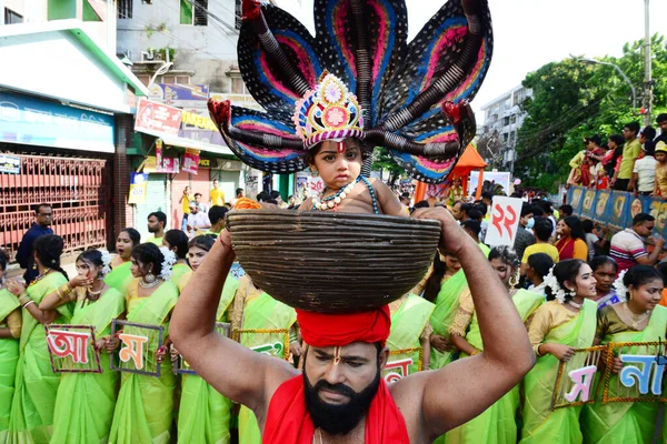 Hindu devotees take part in a procession during celebrations for the 'Janmashtami' festival, which marks the birth of Hindu god lord Krishna, in Dhaka, Bangladesh, on August 19, 2022.