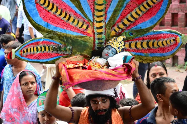 Hindu devotees take part in a procession during celebrations for the 'Janmashtami' festival, which marks the birth of Hindu god lord Krishna, in Dhaka, Bangladesh, on August 19, 2022.