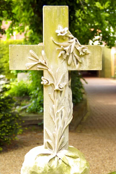 Stone cross with floral motive on a graveyard